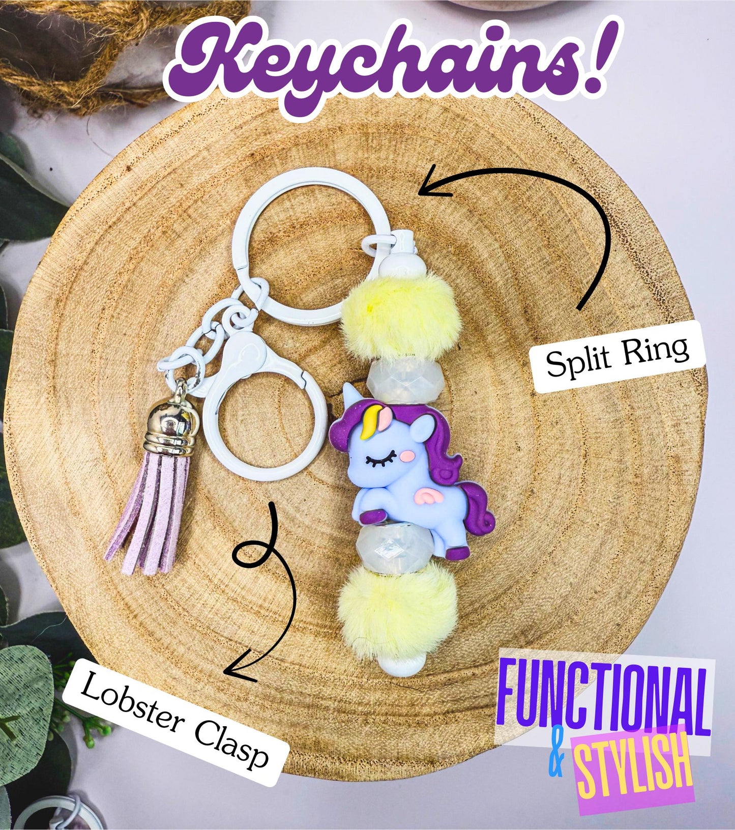 A keychain with a lobster clasp, split ring, and a unicorn charm is displayed on a wooden surface.