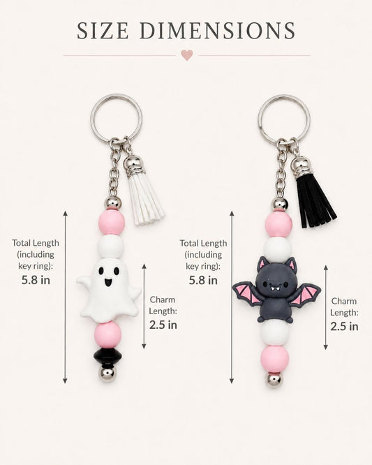 May include: Two Halloween-themed keychains. One features a white ghost charm, the other a black bat. Both have pink, white, and black beads, a silver key ring, and a tassel. Total length is 5.8 inches, charm length is 2.5 inches.