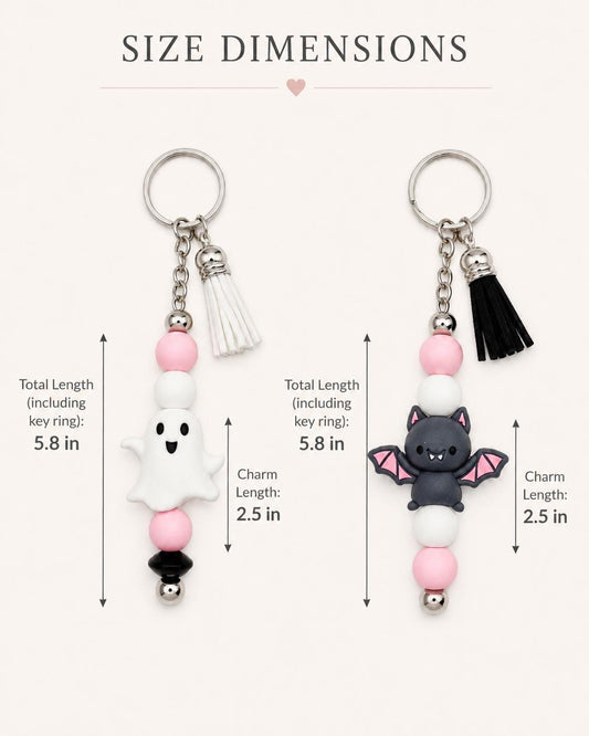 May include: Two Halloween-themed keychains. One features a white ghost charm, the other a black bat. Both have pink, white, and black beads, a silver key ring, and a tassel. Total length is 5.8 inches, charm length is 2.5 inches.